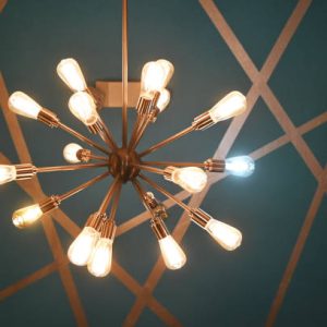 Modern chandelier with one white bulb.